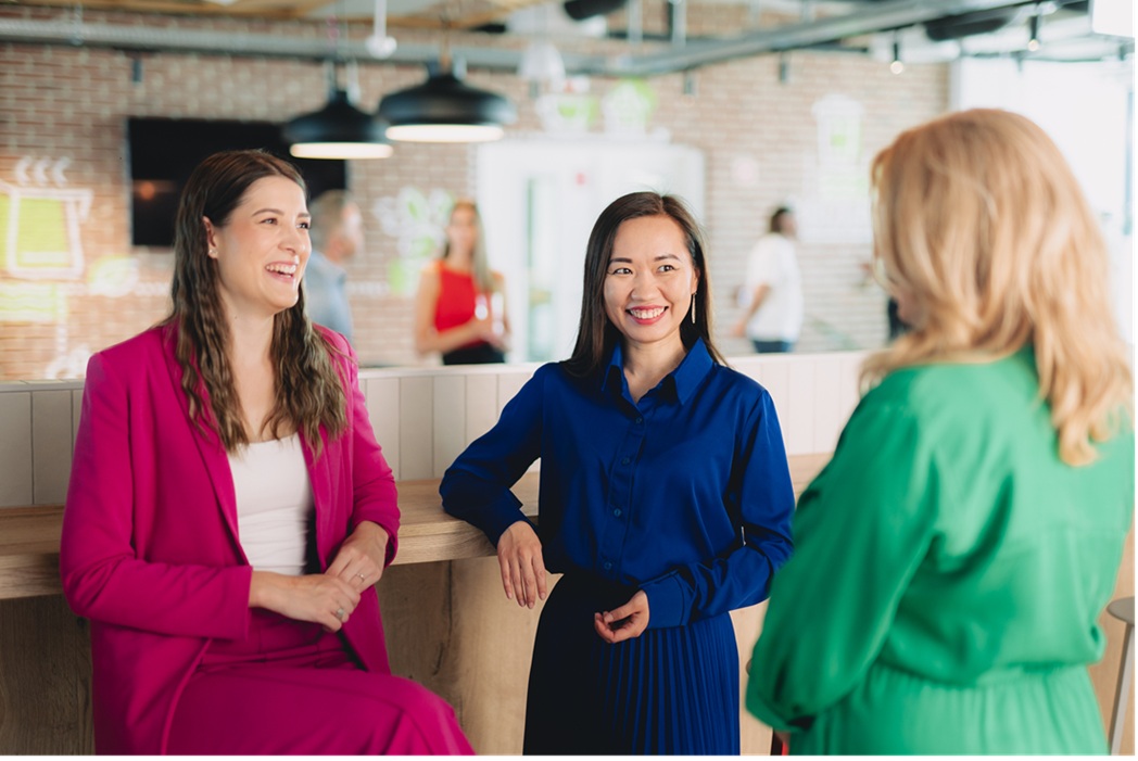Three bp employees in an office having a discussion.