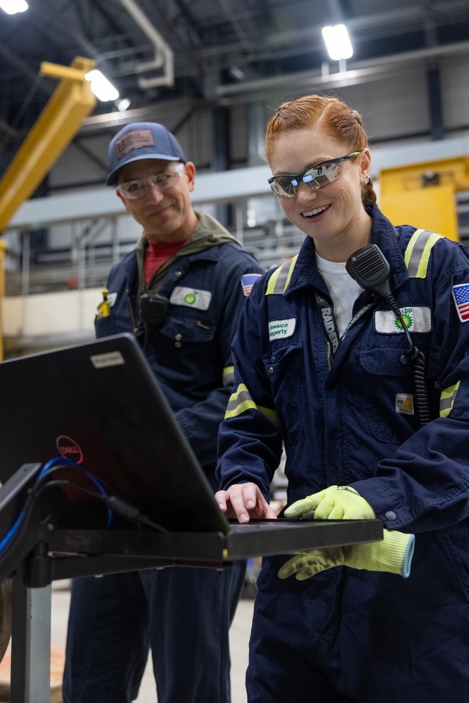 bp engineers collaborating in industrial facility, highlighting engineering, teamwork, and innovation.