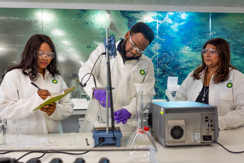 bp scientists in laboratory with protective gear, highlighting research, safety, and innovation.