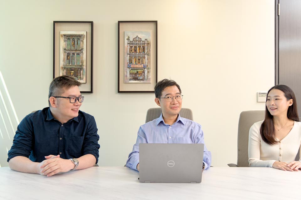 three bp employees having a meeting in the office,