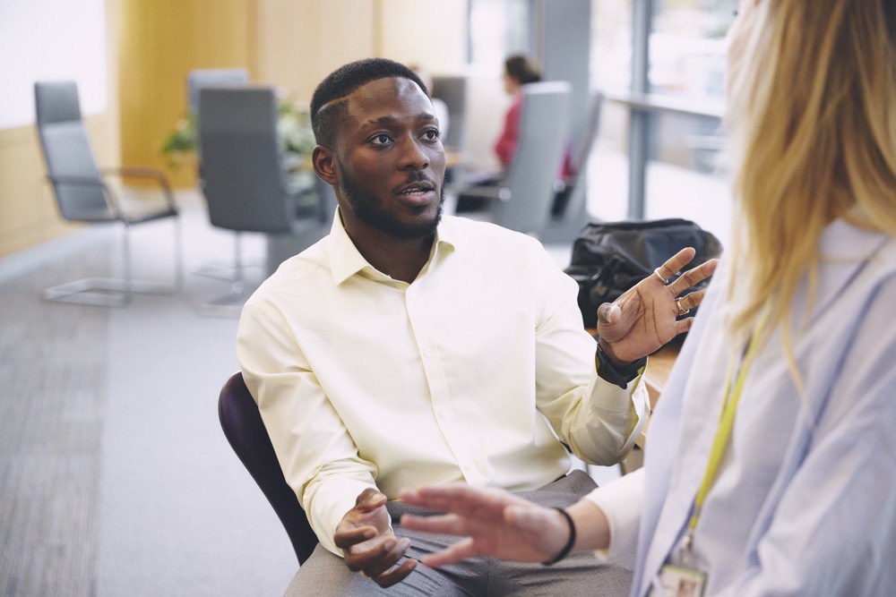 bp employees talking in office, showcasing teamwork, collaboration, and professional development.