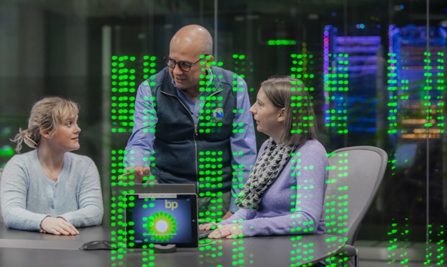 bp technology team collaborating in data center with digital code overlay, showcasing innovation and cybersecurity.
