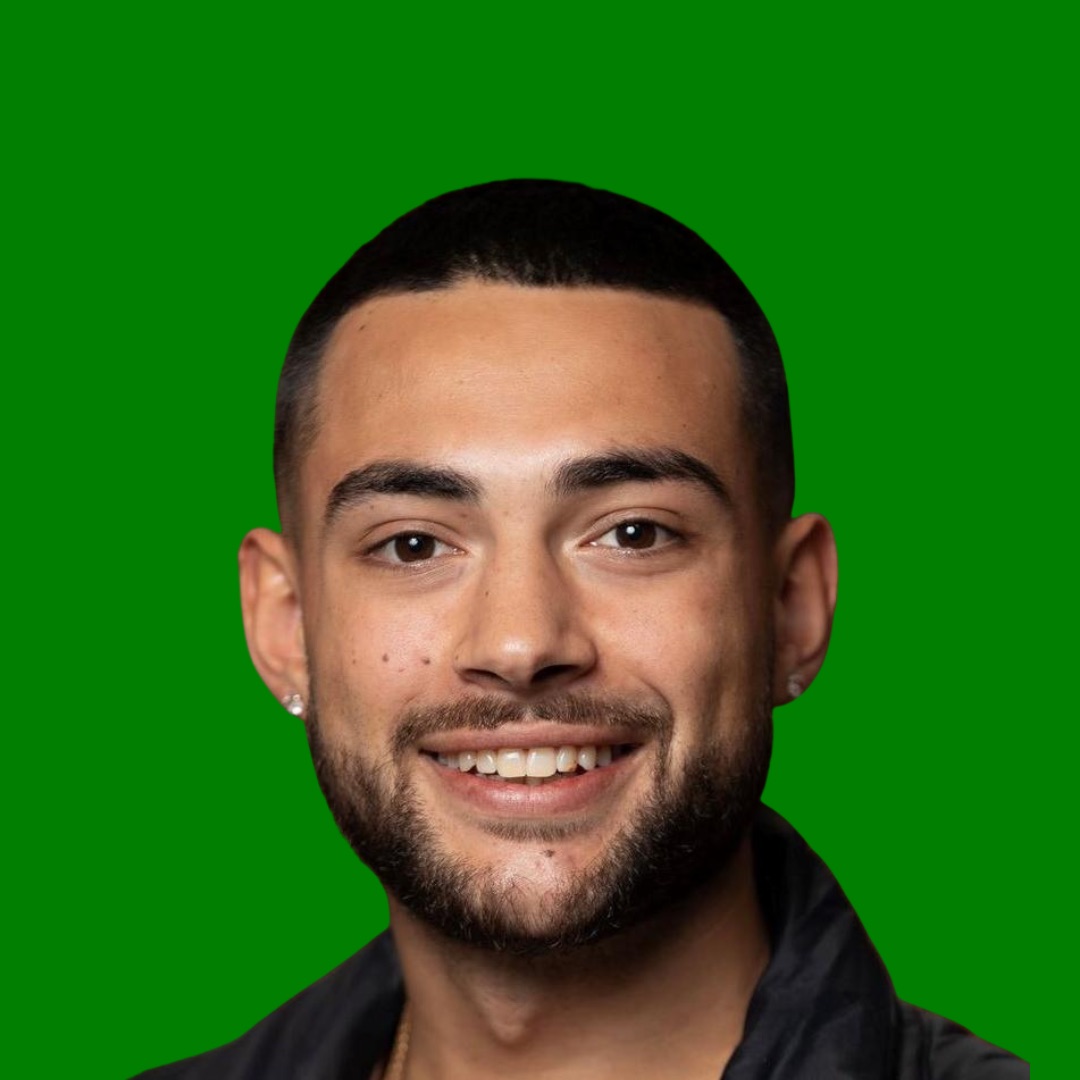 Professional headshot of smiling man on green background.