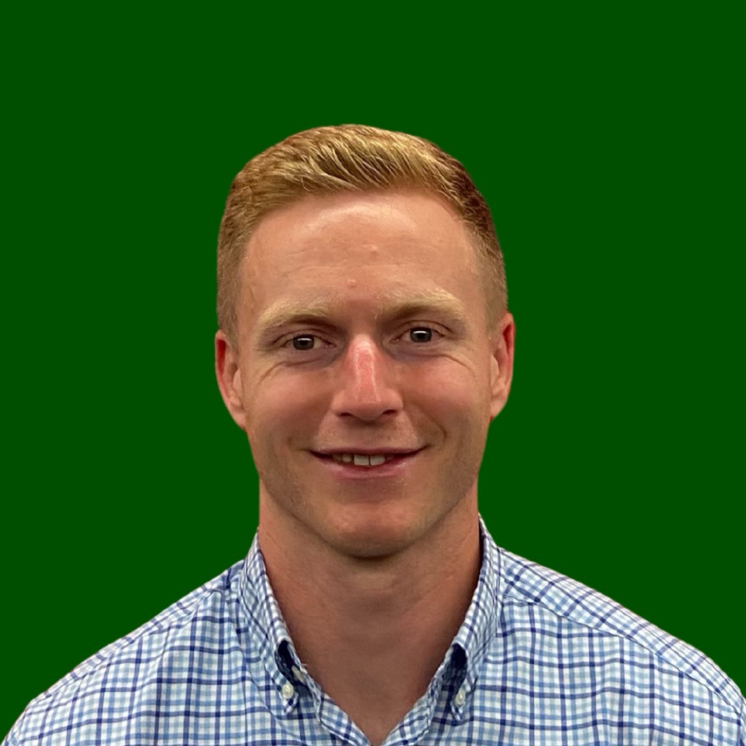 Professional headshot of smiling man on green background.