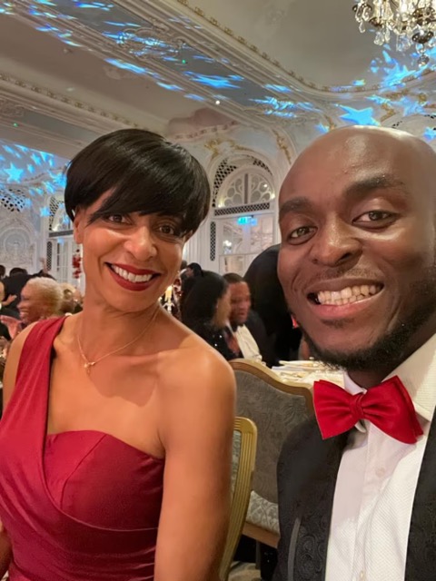 Smiling couple in formal attire at evening gala event.