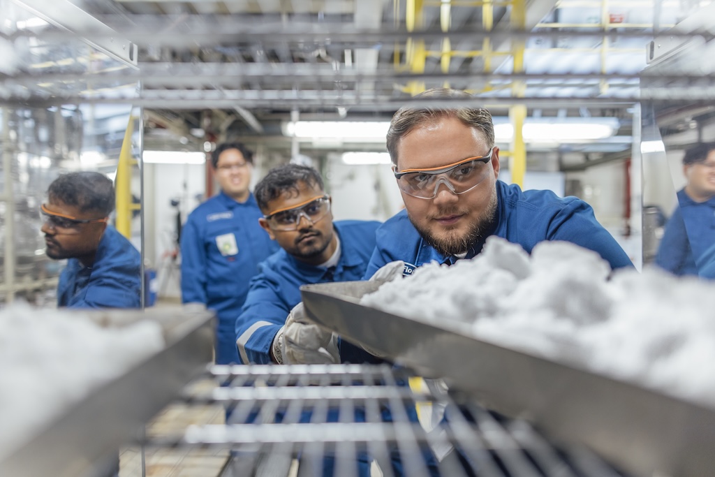 bp engineers in protective gear inspecting industrial equipment, highlighting safety and innovation.