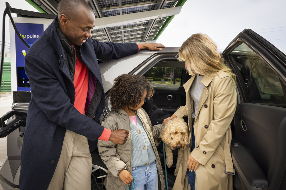 Family at bp pulse EV charging station, highlighting sustainability, clean energy, and family values.